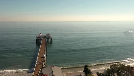 Drone-flying-slowly-over-Malibu-Pier-in-Malibu-near-Los-Angeles,-California