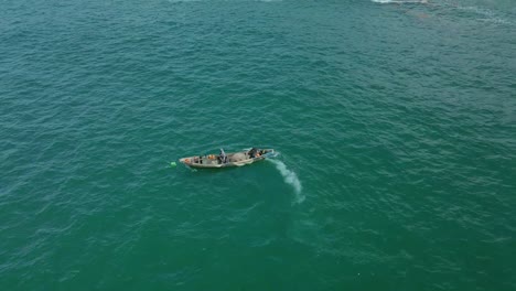 Victoria-Island-Lagos,-Nigeria---20-November-2022:-Drone-view-of-a-fisherman-on-a-fishing-boat-on-the-coastline-of-Lagos