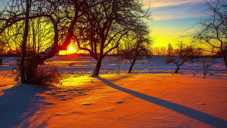 Vibrant-sunrise-time-lapse-of-a-winter-landscape-sliding,-pan-and-tile-motion