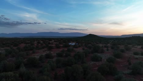 Vehicle-And-Camper-Van-In-Wild-Bushes-Of-Sedona-Desert-In-Arizona-At-Sunset---aerial-drone-shot