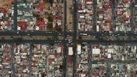 Top-down-aerial-view-from-drone-on-suburban-traffic-junction-of-multiple-lane-road-in-metropolis-city