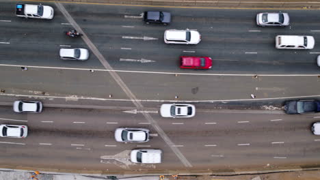 Aerial-birds-eye-view-of-a-busy-road-with-cars-traveling-in-opposite-directions