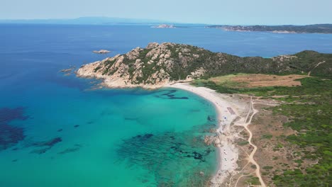 Turquoise-Blue-Bay-and-White-Sandy-Beach-at-Costa-Paradiso,-Sardinia,-Italy---Aerial-4k