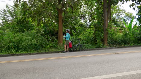 Mujer-Hidratándose-Con-Una-Botella-De-Agua-En-Una-Parada-De-Descanso-En-Su-Viaje-En-Bicicleta