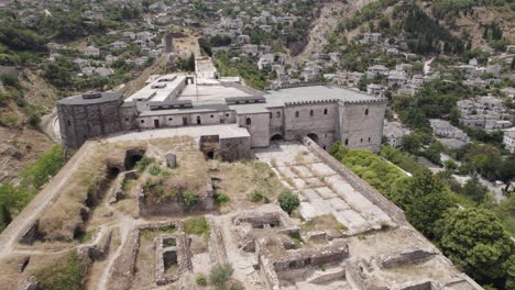 Orbiting-view-of-Gjirokaster-Castle,-stone-ruins-of-the-old-citadel,-Albania-heritage