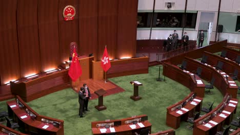 View-of-the-Chinese-emblem-is-seen-above-the-People's-Republic-of-China-flag-at-the-main-chamber-of-the-Legislative-Council-building-known-as-Legco-in-Hong-Kong