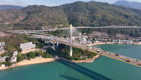 Aerial-view-of-traffic-on-Tin-Kau-Bridge-connecting-Tuen-Mun-and-Tsing-Yi-Island-on-sunny-day-in-Hong-Kong