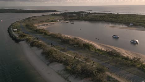 Aerial-view-over-the-Northern-end-of-The-Spit-on-the-Broadwater-on-the-Gold-Coast-moving-towards-Surfers-Paradise,-Queensland,-Australia