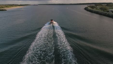 Aerial-view-over-a-boat-on-the-Broadwater-on-the-Gold-Coast-moving-towards-Surfers-Paradise,-Queensland,-Australia