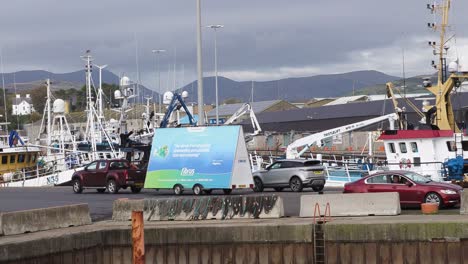 Eine-Schwenkaufnahme-Von-Kilkeel-Harbour-County-Unten,-Die-Die-Vor-Anker-Liegende-Fischereiflotte-Zeigt,-Während-Ebbe-Und-Flut-Die-Boote-Zum-Steigen-Und-Sinken-Bringen