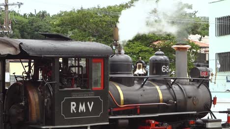 ancient-steam-train-prepares-to-departure-from-station,-releasing-smoke