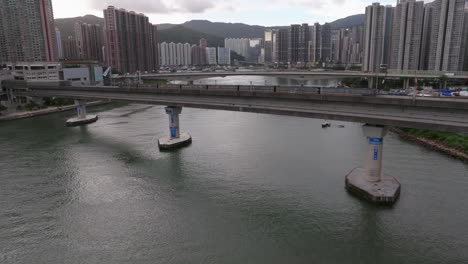 Aerial-tracking-shot-following-train-crossing-a-bridge-over-the-ocean-in-Hong-Kong