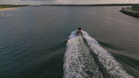 Aerial-view-over-a-boat-on-the-Broadwater-on-the-Gold-Coast-moving-towards-Surfers-Paradise,-Queensland,-Australia