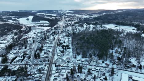 High-aerial-truck-shot-of-housing-and-roads-covered-in-snow-on-winter-day-in-ski-resort-town