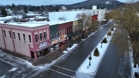 Aerial-reveal-of-buildings-and-stores-lining-main-street-in-Wellsboro-PA