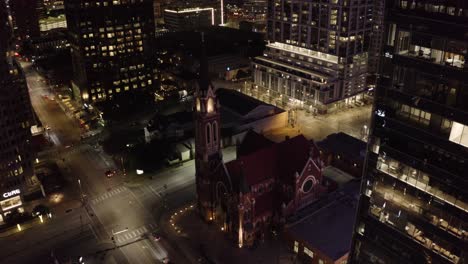 Aerial-view-of-a-church-at-night-in-the-downtown-district-of-Dallas,-Texas