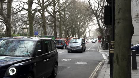 13-January-2023---London-Black-Cab-Driving-Past-Along-Millbank-With-Roadworks-In-Background