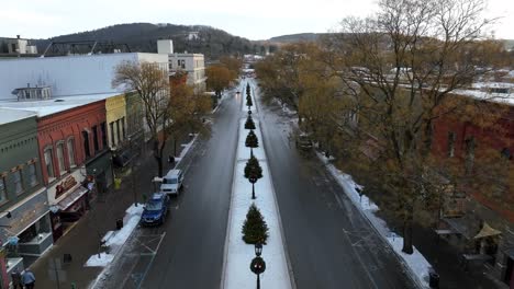 Slow-cinematic-descending-aerial,-tilt-up-reveal-down-main-street-of-Wellsboro-PA