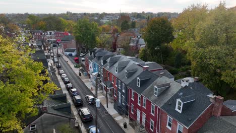 Rising-aerial-of-beautiful-colorful-houses-in-city-during-autumn-sunset