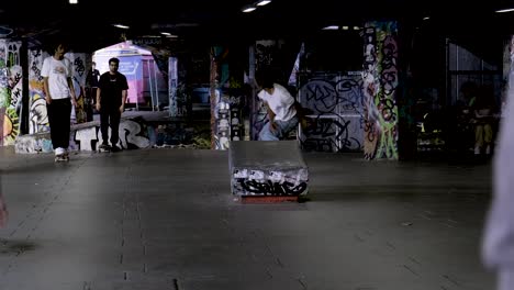 One-skateboarder-does-a-jump-as-people-Skateboarding-in-the-skate-park-Southbank-Center,-London,-UK