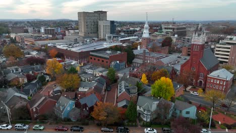 High-aerial-flight-towards-inner-city-church-steeple-in-America