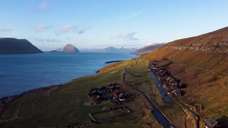 Aerial-drone-view-of-Kirkjubøur-village,-Faroe-Islands,-on-a-sunny-summer-day