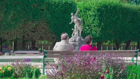 An-elderly-couple-sitting-on-a-bench-and-taking-a-rest