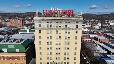 Slow-aerial-rising-shot-of-Genetti-Hotel-in-Williamsport-Pennsylvania-on-snowy-day