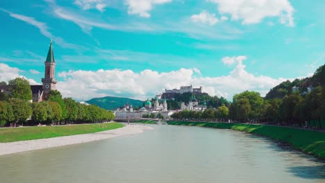 View-from-Müllnersteg-bridge,-Salzach-river,-towards-Fortress-Hohensalzburg-in-Salzburg,-Austria