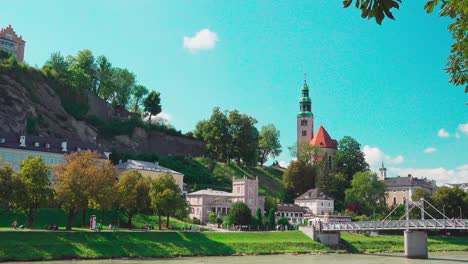 View-From-Elisabethkai-Towards-Müllnersteg-Footbridge-And-Müllner-Church-In-Salzburg,-Austria