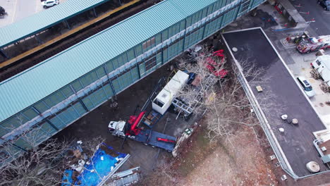 Birds-Eye-Aerial-View-of-Cranes-and-Massive-Air-Conditioning-Unit-Prepared-to-Lift-Up