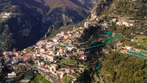 Amalfi-scenic-lush-mountain-valley-town-aerial-view-orbiting-idyllic-Italian-rocky-cliff-landscape