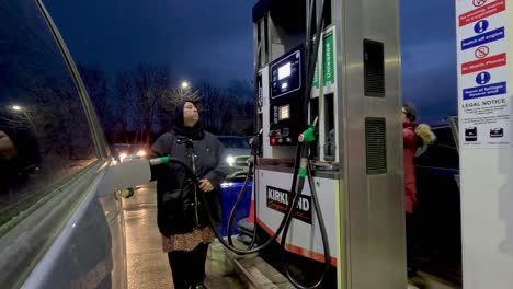 14-January-2023---UK-Muslim-Women-Filling-Up-Petrol-At-Costco-Petrol-Station-In-Watford