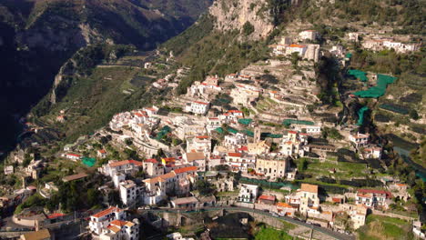Picturesque-Amalfi-village-houses-aerial-view-flying-over-idyllic-mountain-town
