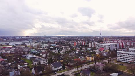 Private-home-area-in-Riga-suburbs-with-TV-tower-in-horizon,-aerial-view