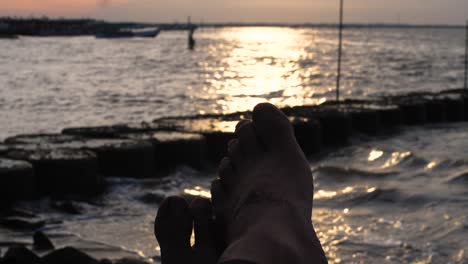 slow-motion-close-up-of-feet-with-ocean-background