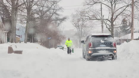 Car-reversing-through-thick-snow-on-road---winter-blizzard,-Fort-Erie,-Canada