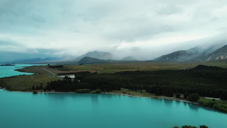 New-Zealand-Aerial-Drone-View-of-Lake-Tekapo-with-Misty-Pine-Forest-in-Distance