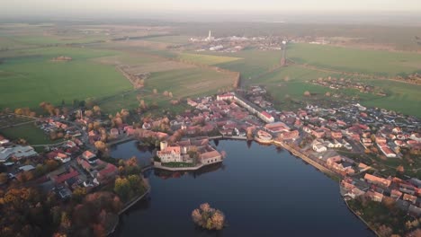 Panoramic-uninterrupted-aerial-view-of-drone-gliding-around-Flechtingen-water-castle,-Wasserburg-Flechtingen,-Germany