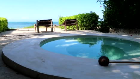Panning-right-shot-of-a-terrace-with-a-private-circular-pool-with-Indian-Ocean-views-in-luxurious-resort