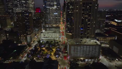 Tiro-De-Drone-Volando-Lejos-Del-Centro-De-La-Ciudad-De-Houston,-Noche-En-Texas,-Estados-Unidos