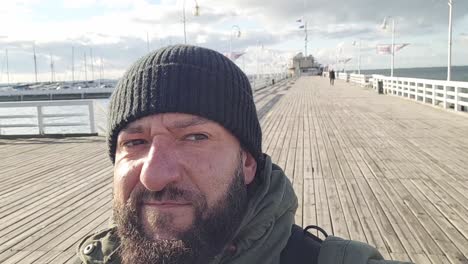 man-walking-on-the-pier-of-the-city-of-sopot-in-poland