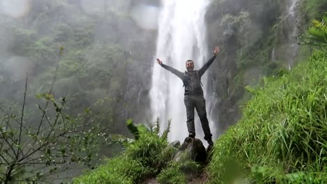 Slowmotion-shot-of-an-exhausted-man-shouting-after-reaching-the-Materuni-waterfall