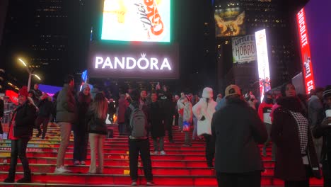 Crowded-People-Taking-Photos-At-Times-Square-Red-Steps-In-New-York-City,-United-States