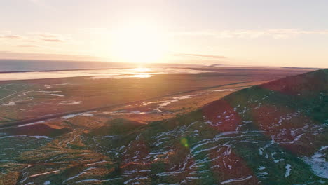 Autumn-sunrays-across-Skaftafell-nature-reserve,-Vatnajökull-national-park-in-south-east-Iceland,-Aerial-view
