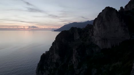 Amalfi,-Italy-Coastline-Aerial-towards-the-mountain-at-sunset