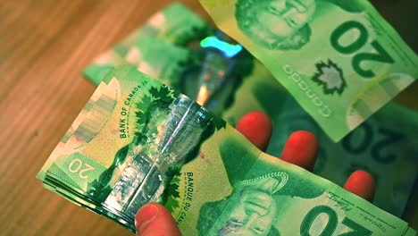 Caucasian-man's-hands-sorting-through-stack-of-Canadian-20-dollar-bills,-placing-them-on-table