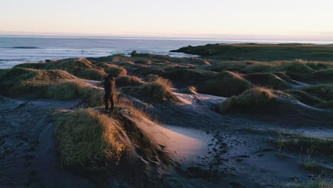 Male-photographer-capturing-the-breathtaking-landscapes-of-Stokksnes-beach-in-Iceland-at-sunrise