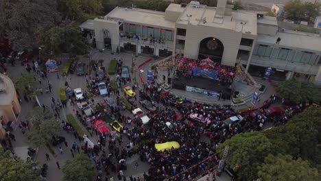 Aerial-Dolly-Towards-Auto-Show-Car-Meet-At-Port-Grand-Avenue-During-Sunset