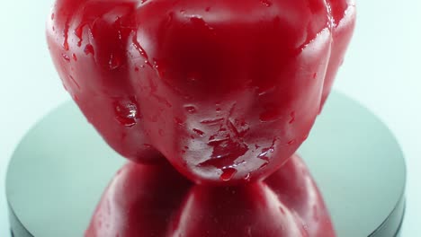 A-close-up-shot-of-a-sweet-red-wet-pepper-on-a-reflecting-rotating-stand-360,-slow-motion,-4k-video